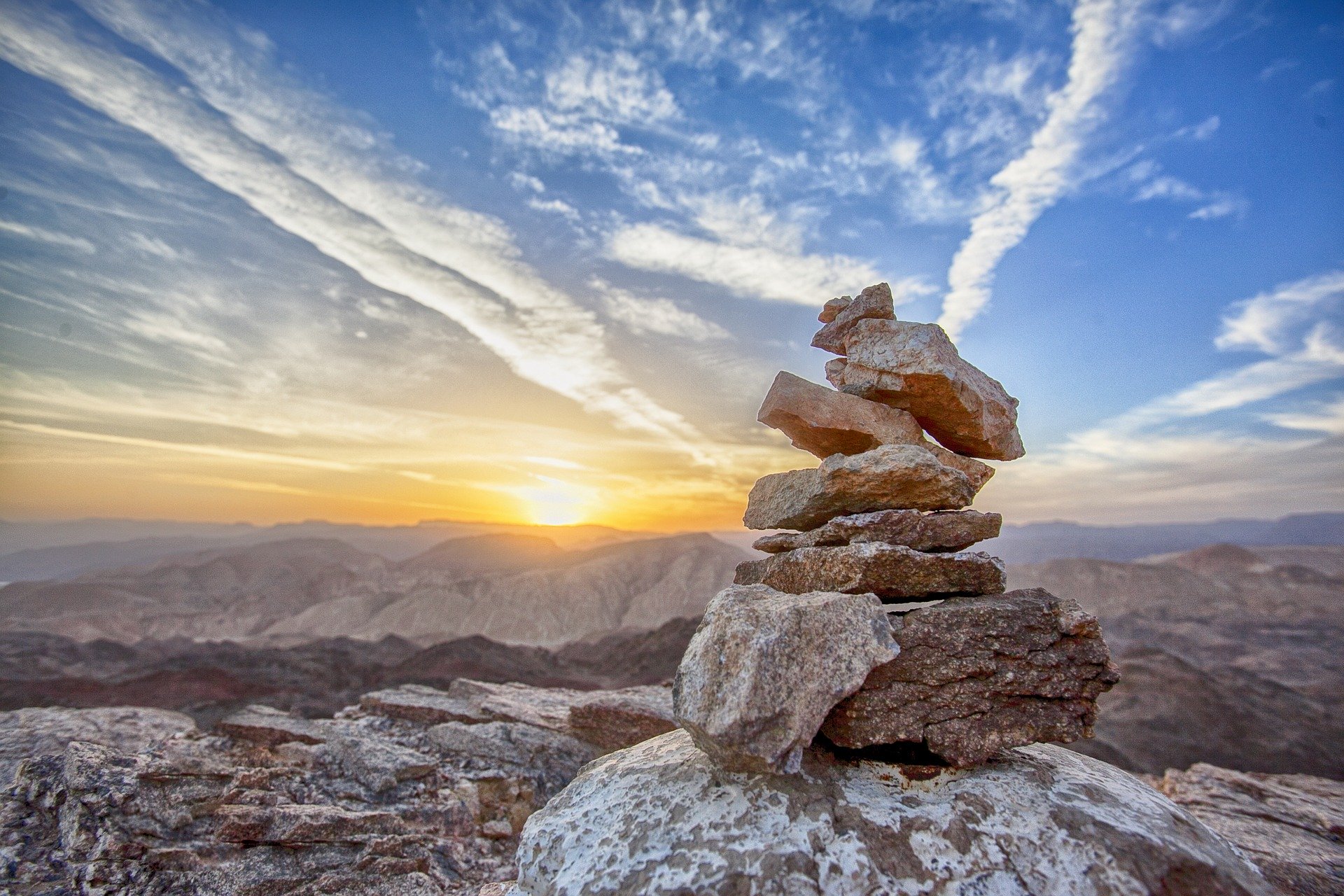 stones balanced on top of each other with sunset background